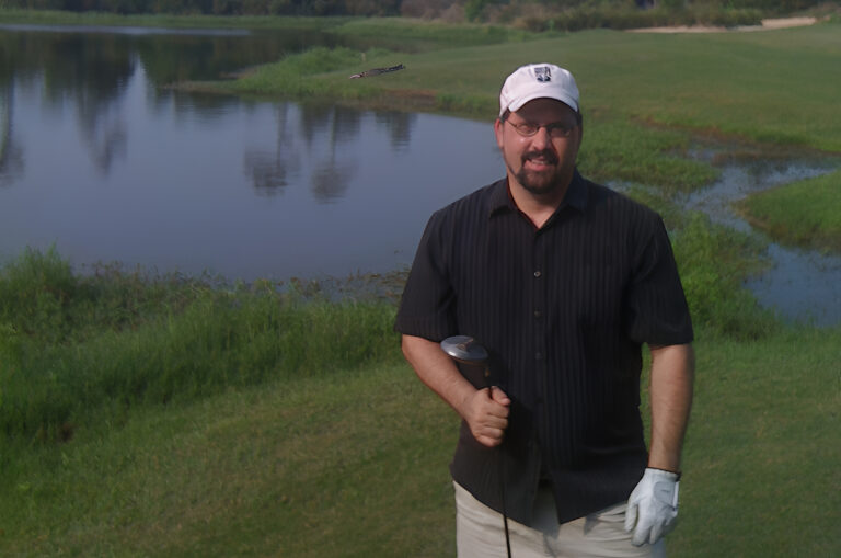 Me, golfing in Mississippi, with an alligator behind me.