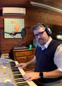 Me, composing on the computer with my 66-key MIDI keyboard.