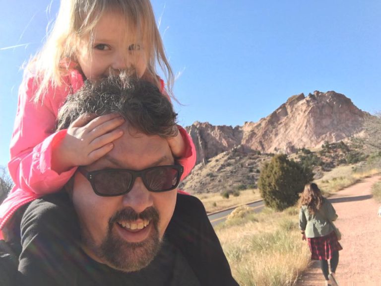 Carrying Charlie piggyback in the Colorado high desert.