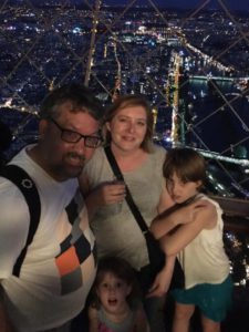 With the kids at the top of the Eiffel Tower at midnight.