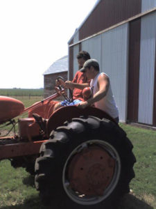 Learning to drive a tractor in Storm Lake, Iowa.