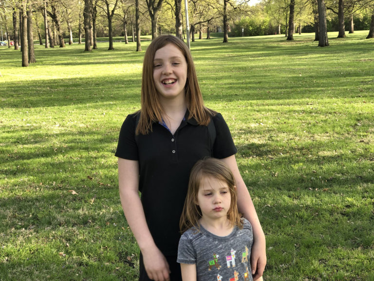 Only one daughter at a time will smile for photos. They take turns.