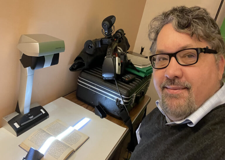Me, scanning a 100-year-old Aulén text to read and consider.